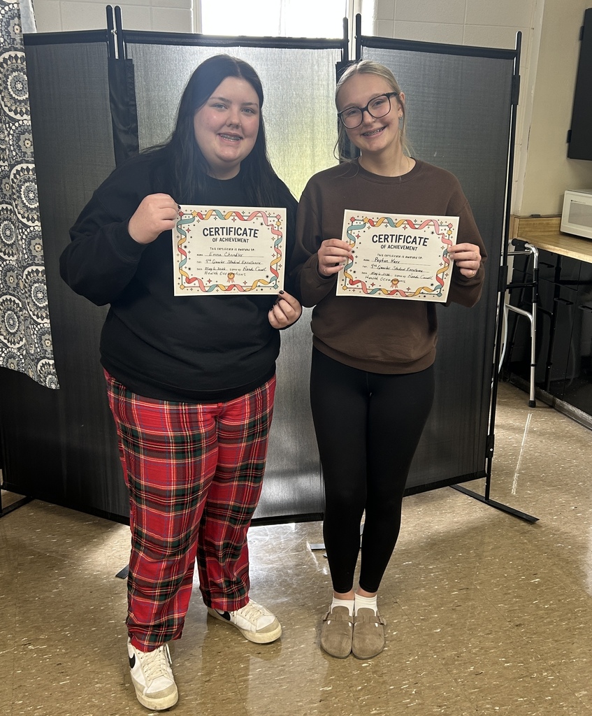 Emma Chandler and Peyton Kerr holding certificates