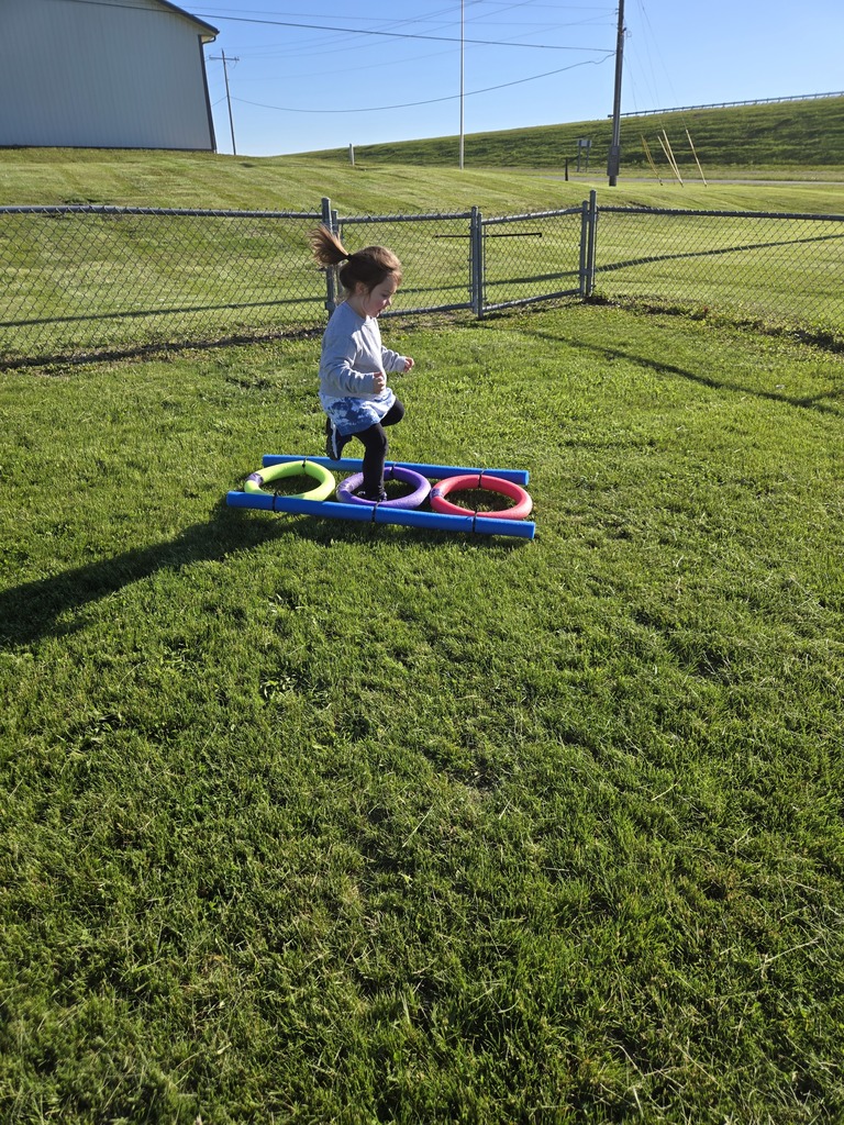 Preschool students from Miss Emily’s class playing outside together during end-of-year activities, enjoying outdoor games, running, and smiling in a park or playground setting.