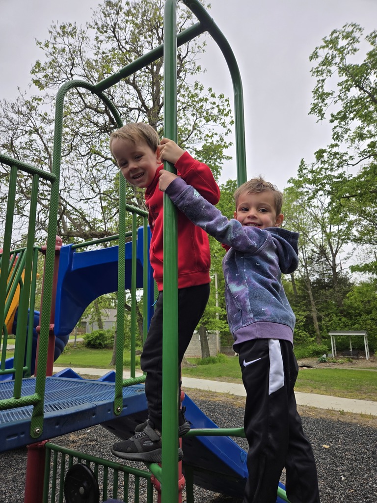 Preschool students from Miss Emily’s class playing outside together during end-of-year activities, enjoying outdoor games, running, and smiling in a park or playground setting.