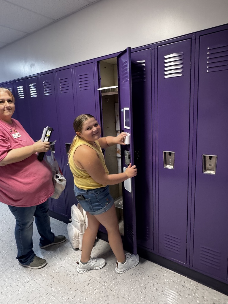 5th graders smile as they decorate and organize their new middle school lockers.