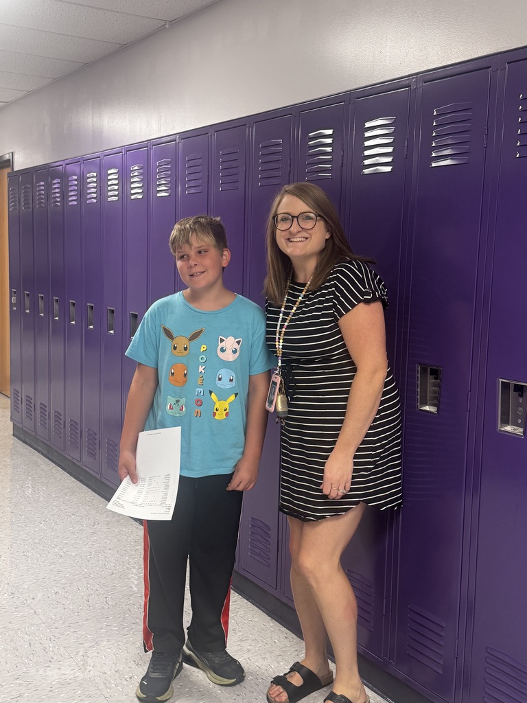 Ms. McConkey poses with a 5th grader during 5th grade orientation
