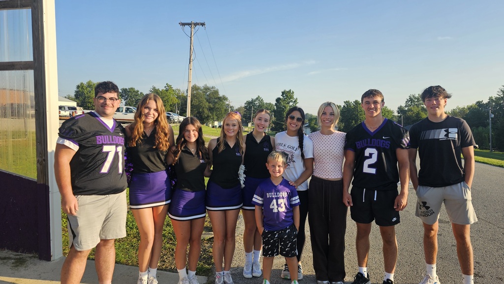 High School Athletes pose together in the student drop off area at the Elementary School