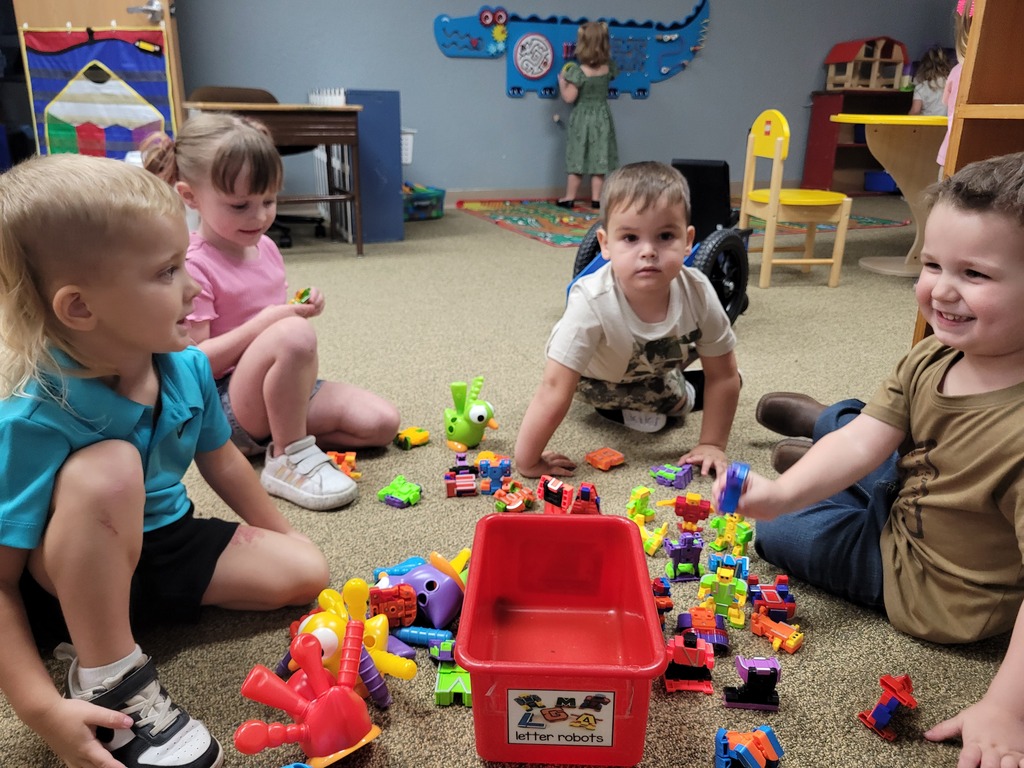 kids all playing with blocks using teamwork and imagination to play