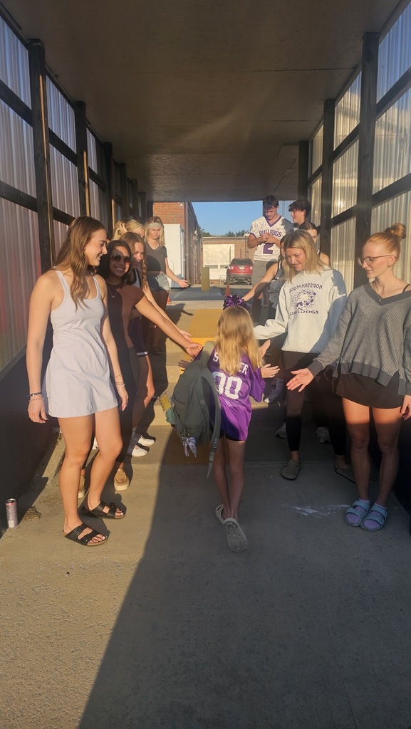 Elementary student is greeted walking into the Elementary school