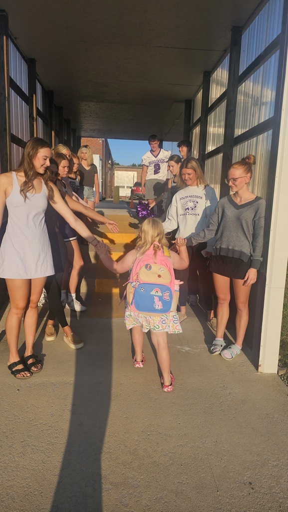 Elementary student is greeted walking into the Elementary school