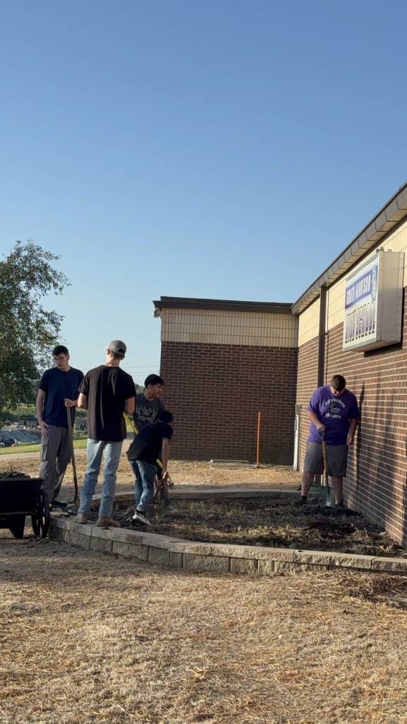 Students work on the new native planting project.