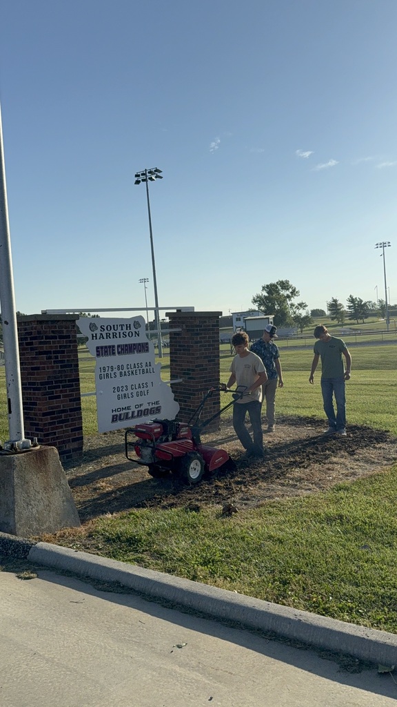 Students prepare the area for Missouri native grasses.