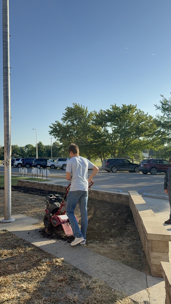 Students prepare the area for Missouri native grasses.