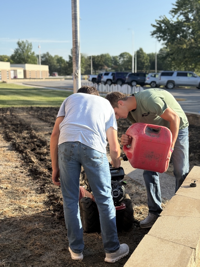 Students prepare the area for Missouri native grasses.