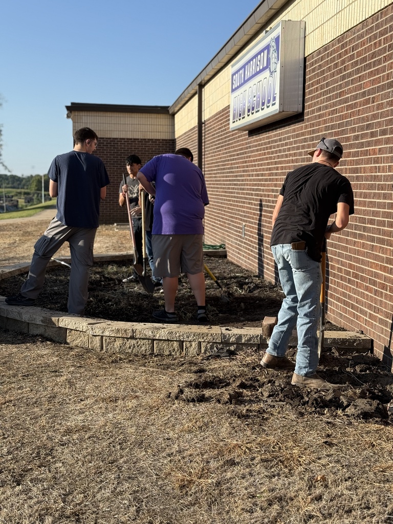 Students work on the new native planting project.