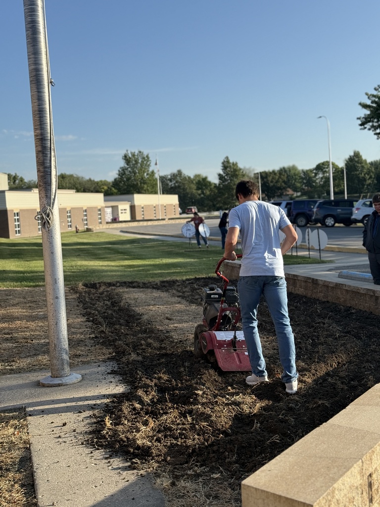 Students prepare the area for Missouri native grasses.