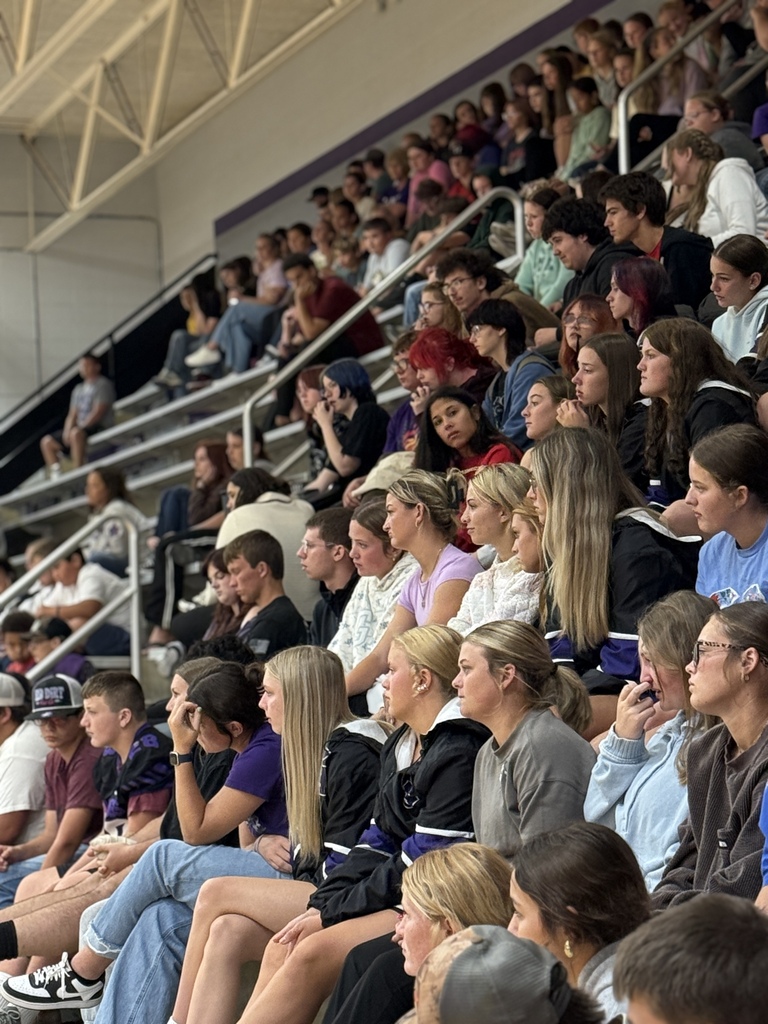 Students seated together in the stands listening attentively during a suicide awareness assembly.