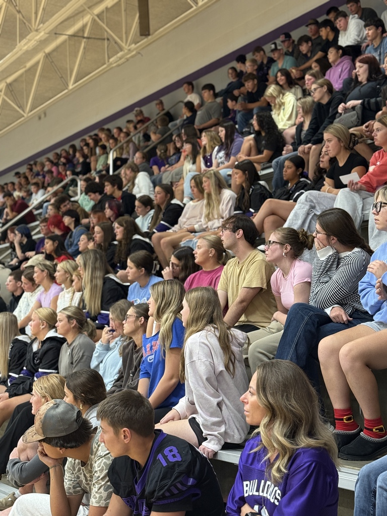 Students seated together in the stands listening attentively during a suicide awareness assembly.