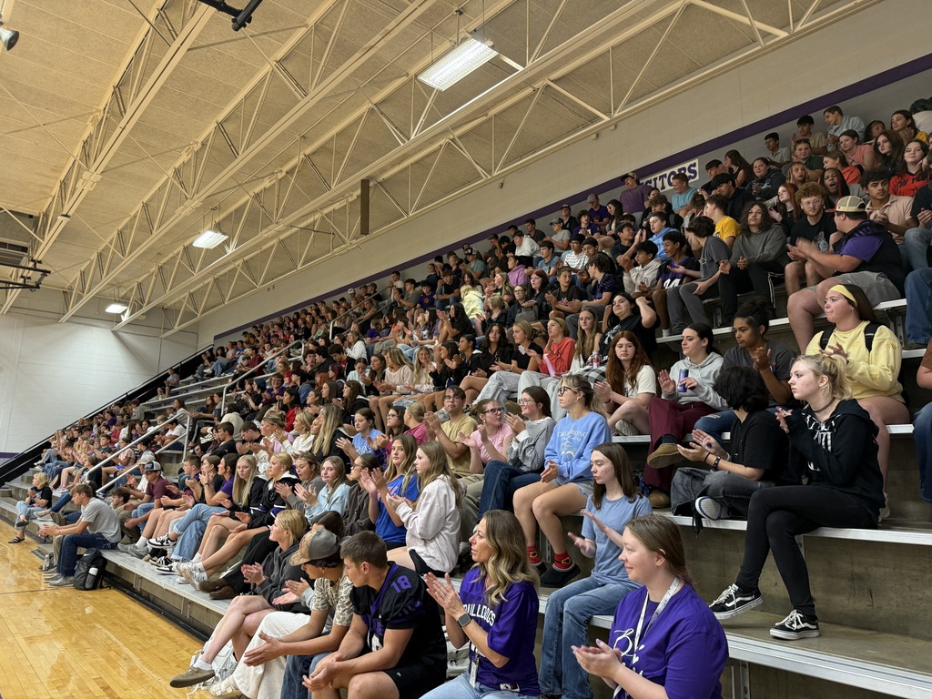 Students seated together in the stands listening attentively during a suicide awareness assembly.