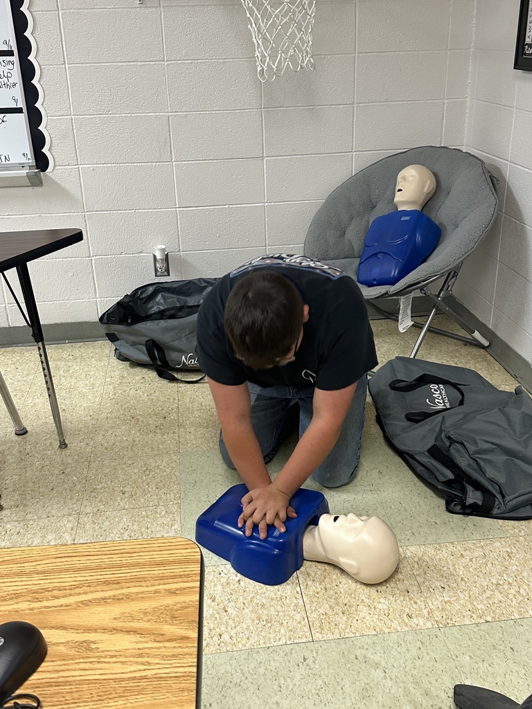 Student practices CPR on a mannequin