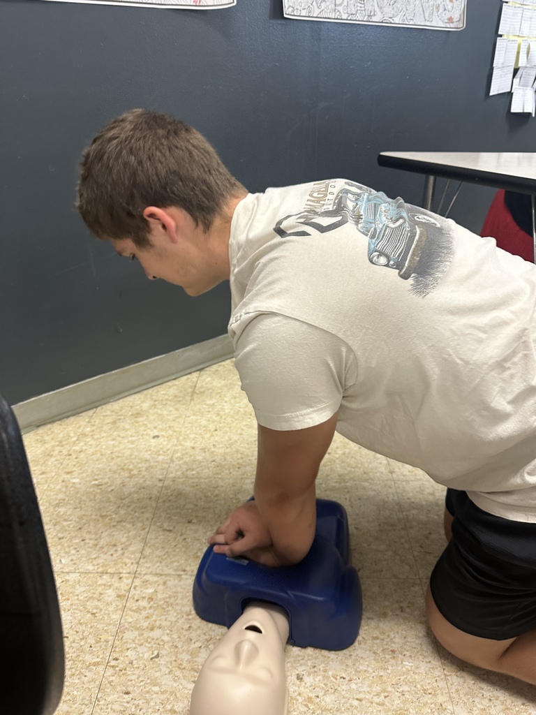 Student practices CPR on a mannequin