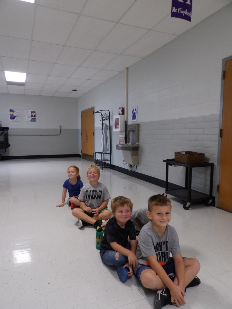 Photo shows kids lined up after a restroom break, ready to go back to class.
