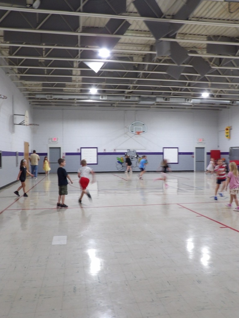 Elementary students playing a game of dodgeball in p.e class
