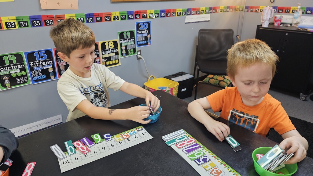 2 Students playing number matching games in a classroom