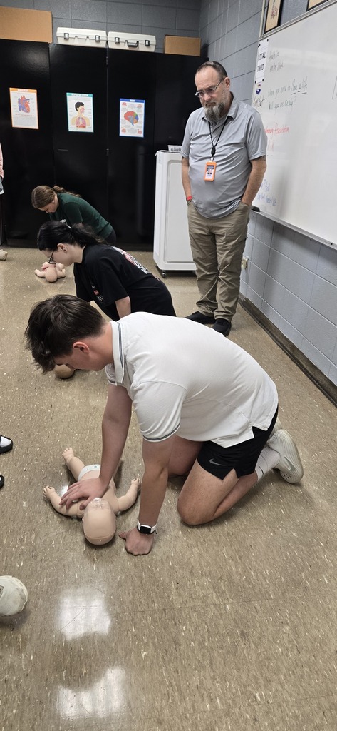Student being helped through CPR