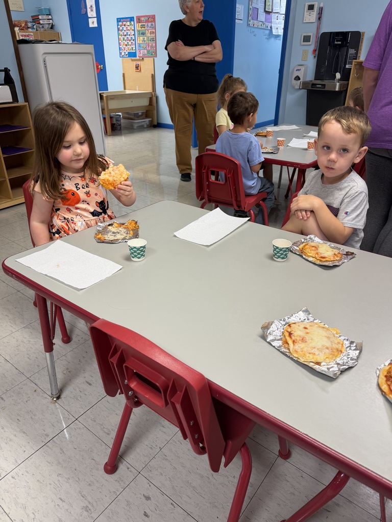 two kids eating pizza