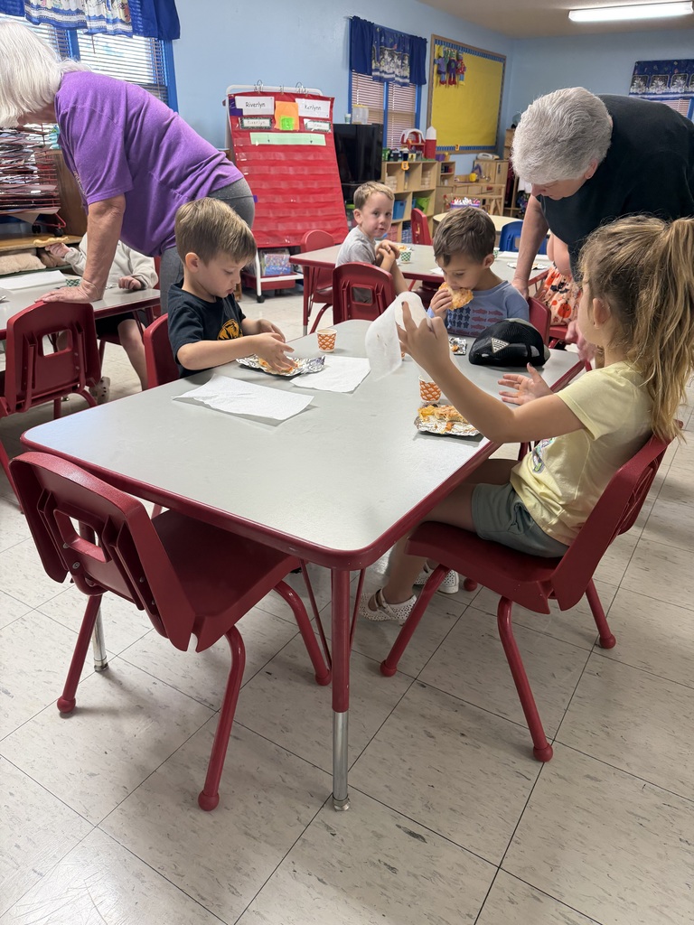 three kids eating pizza