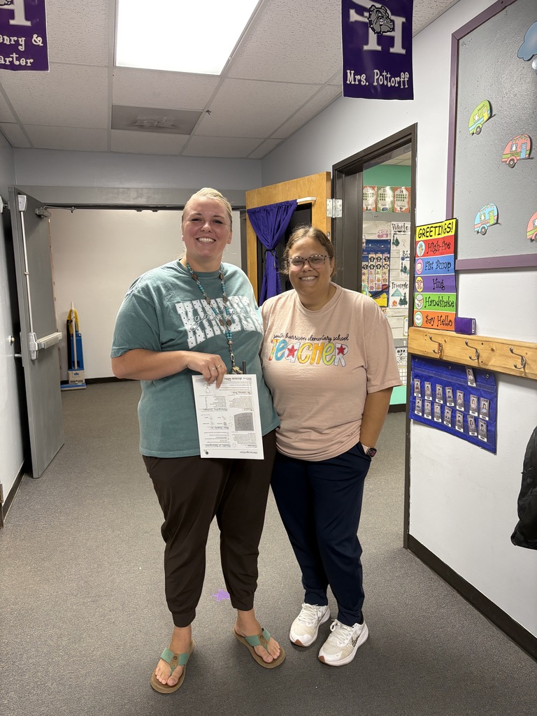Teacher Mrs. Pottorf and Mrs. Mossburg standing in the hallway posing for a picture