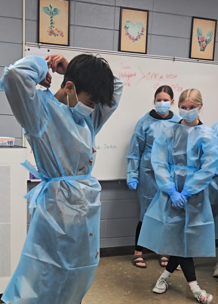 Boy putting on PPE