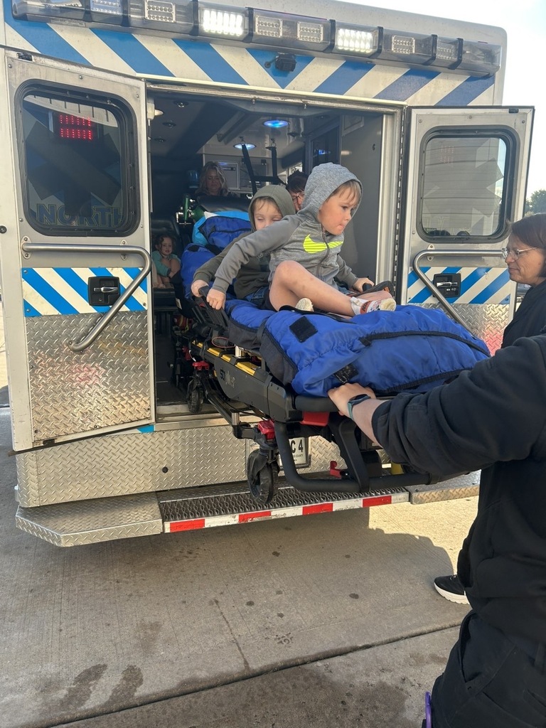 kids riding down ambulance bed