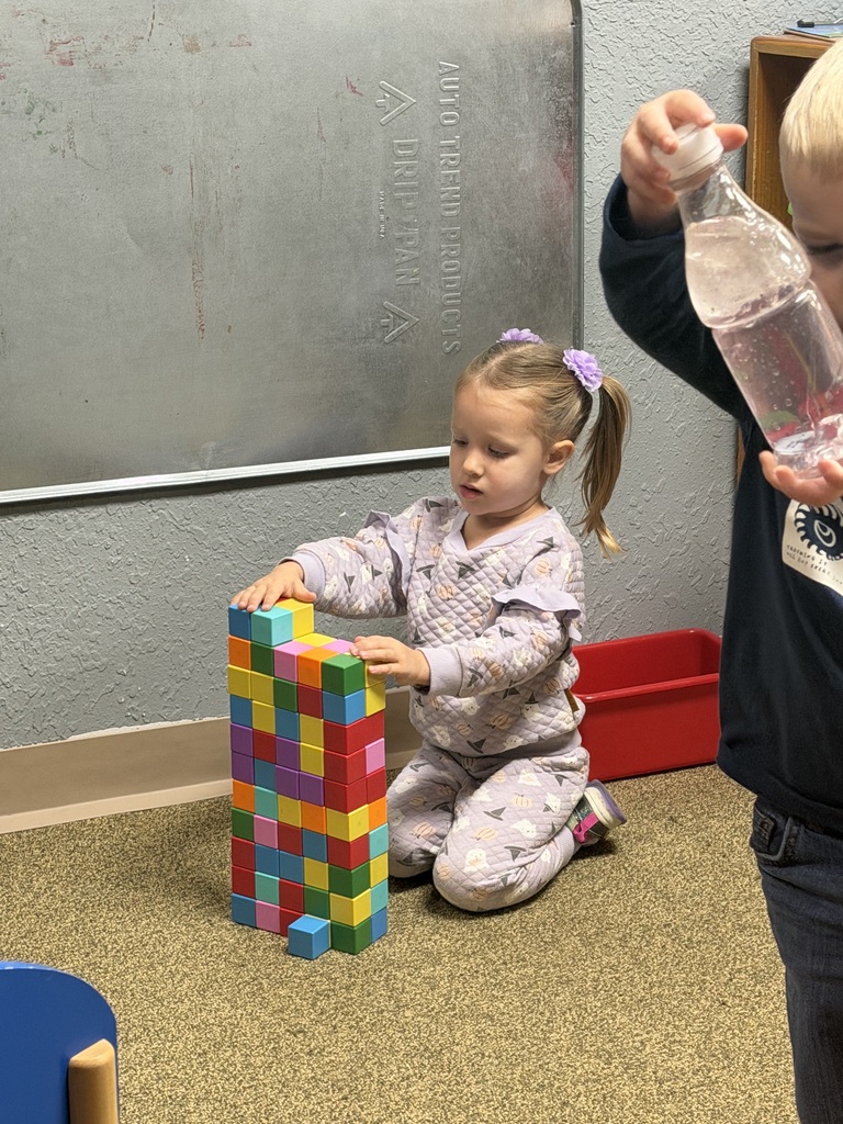 giorl making tower with blocks
