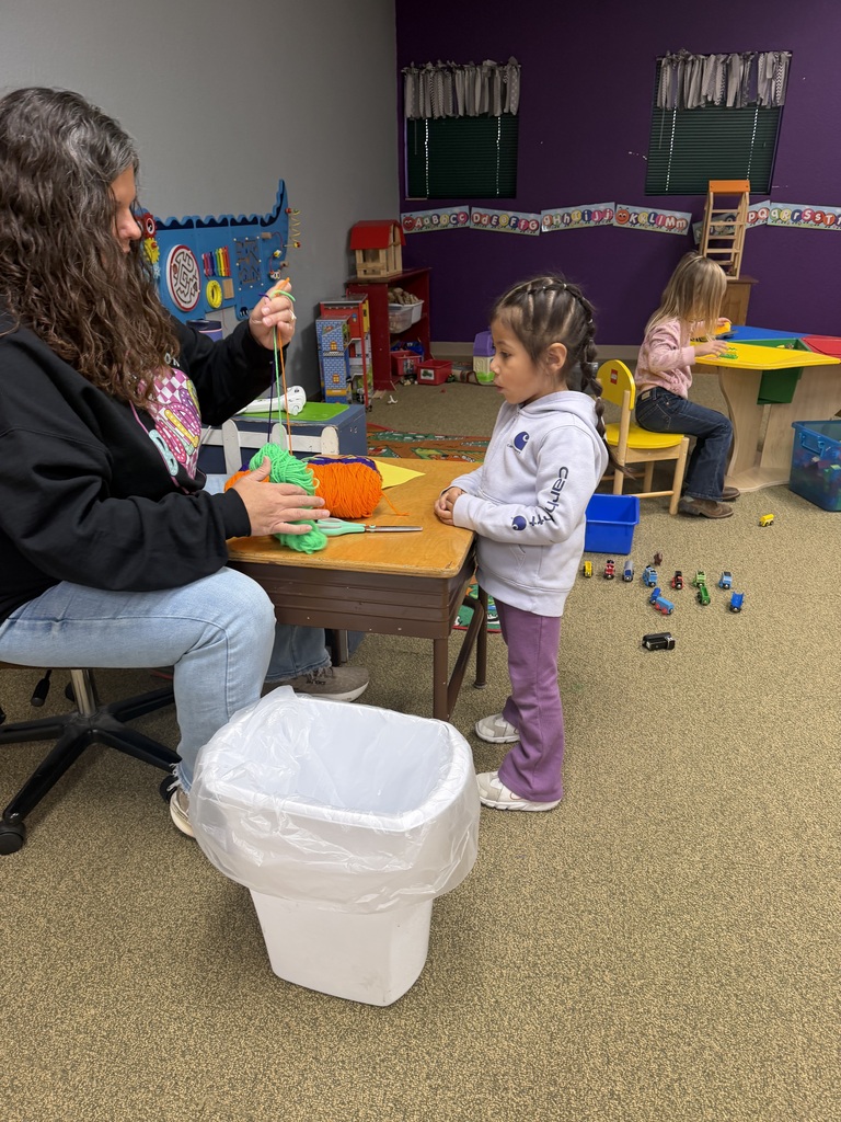 girl making craft with teacher
