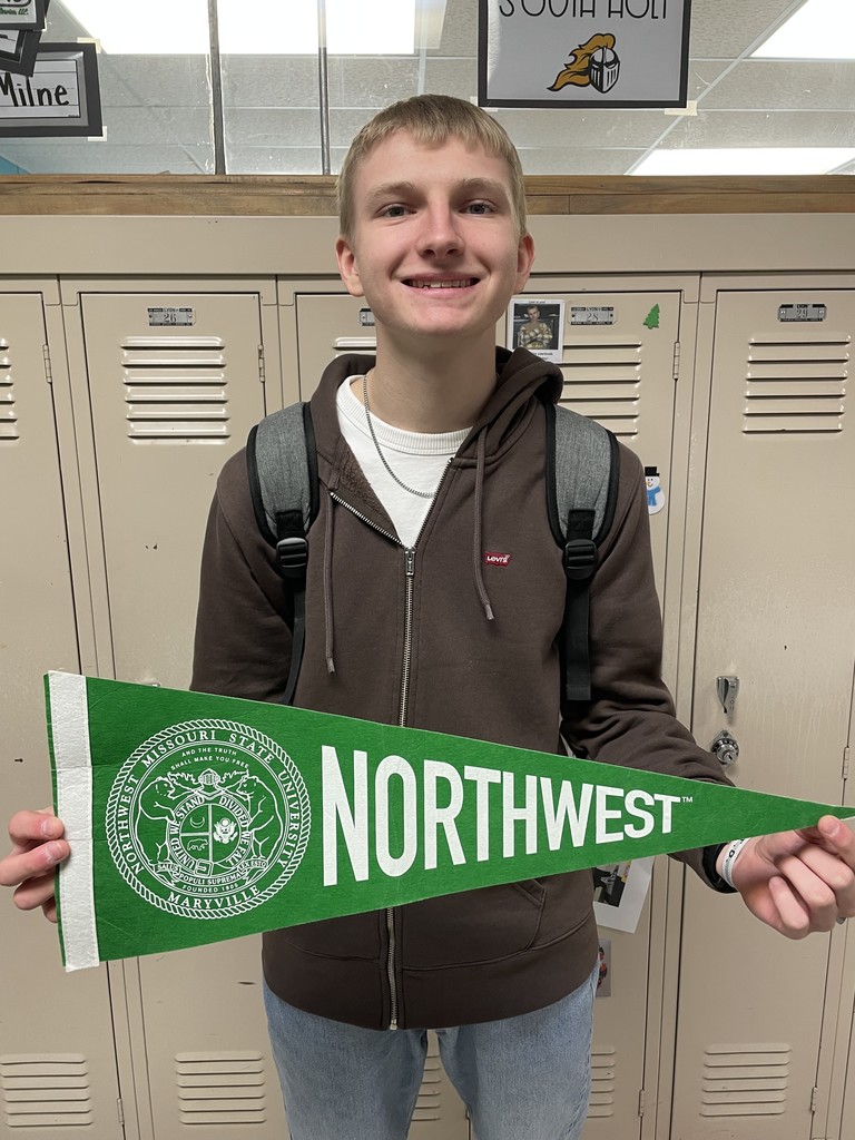 student holding college pennant