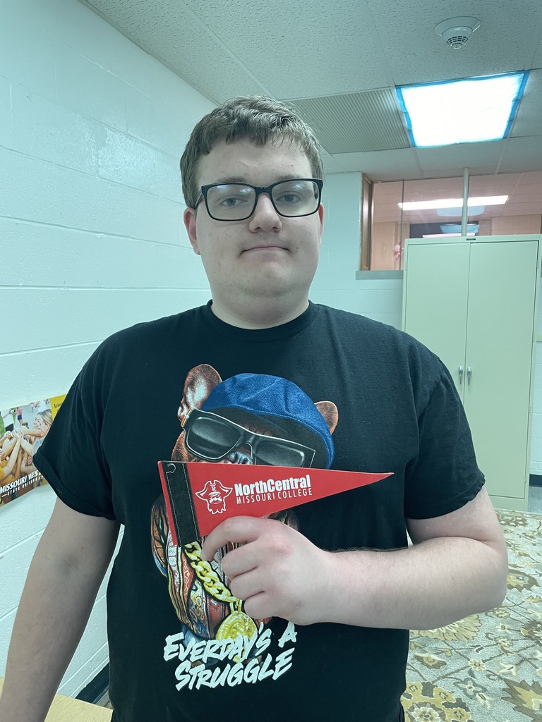 student holding college pennant