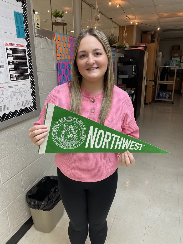 student holding college pennant