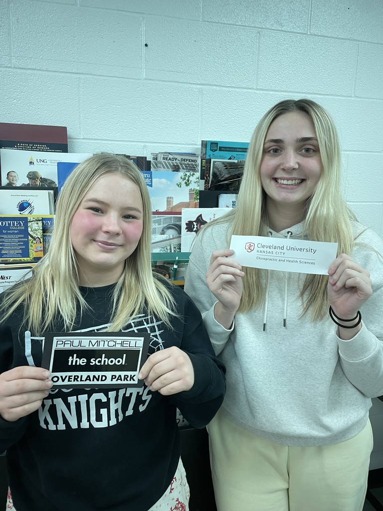 students holding college pennant
