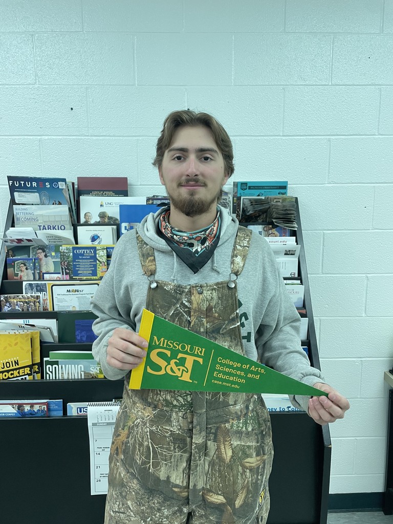 student holding college pennant