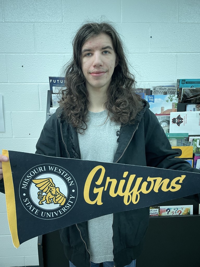 student holding college pennant