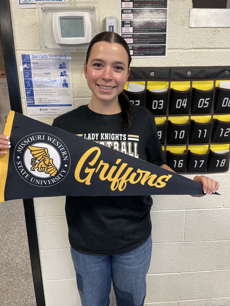 student holding college pennant