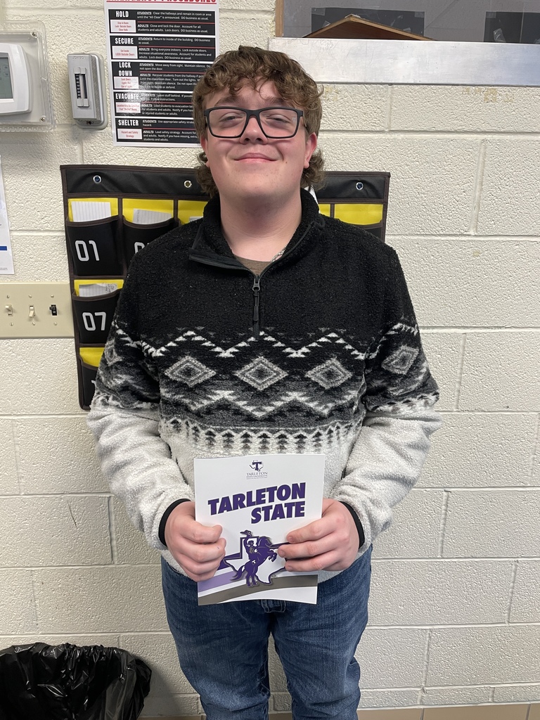 student holding college pamphlet