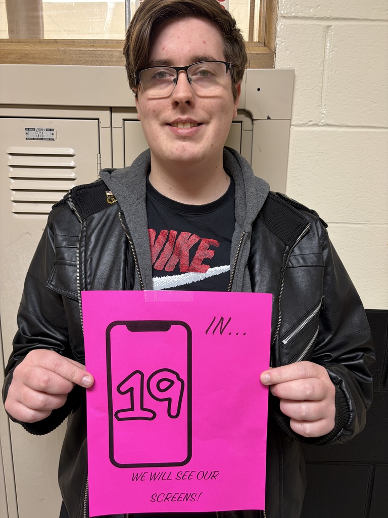 Student holding sign