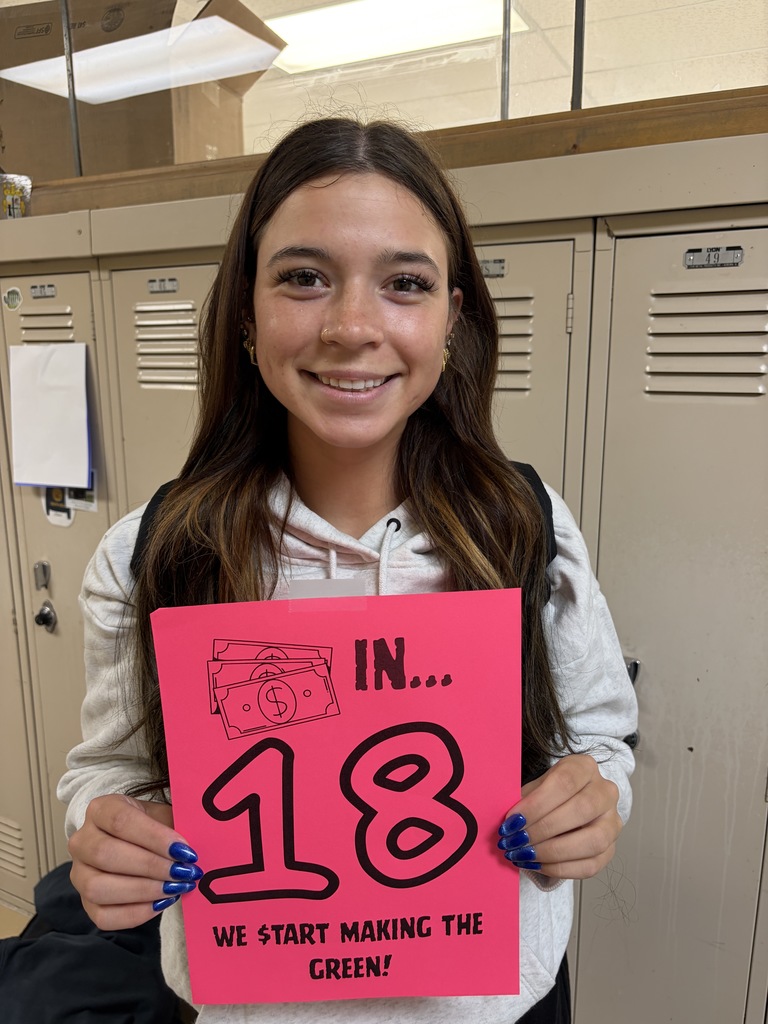 Student holding sign