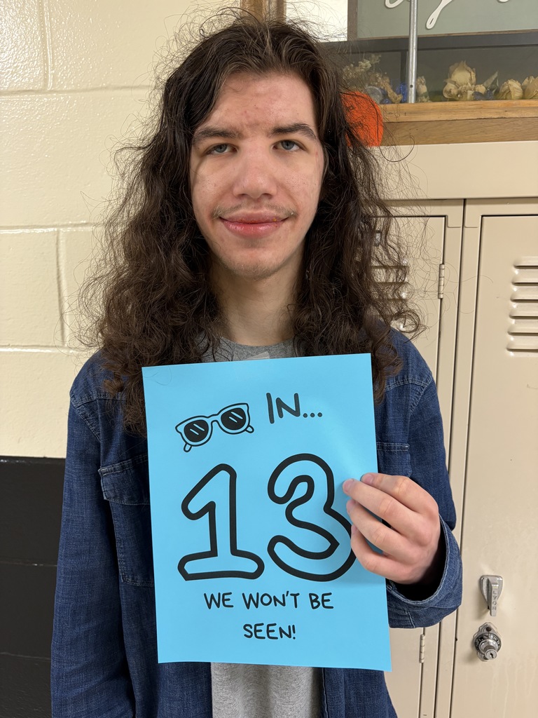 Student holding sign