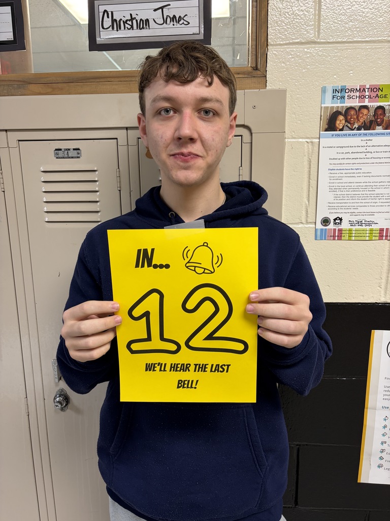 Student holding sign