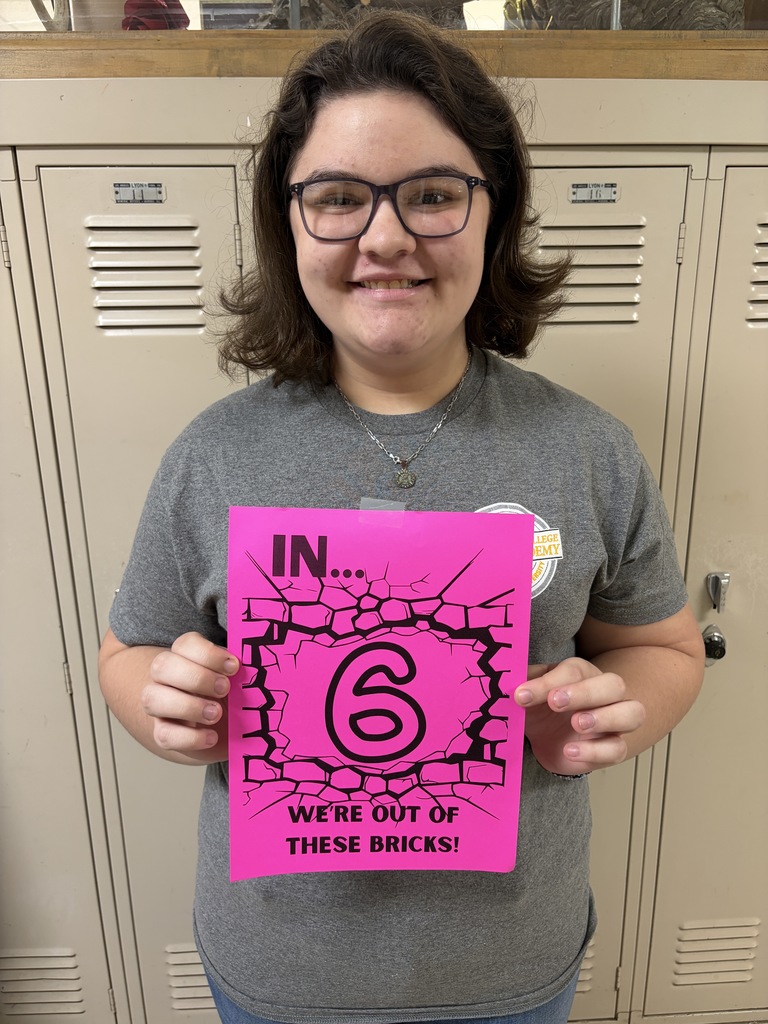 Student holding sign