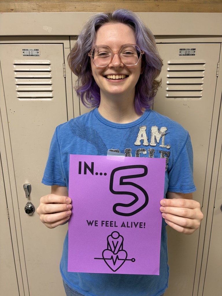 Student holding sign