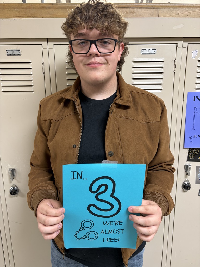 Student holding sign