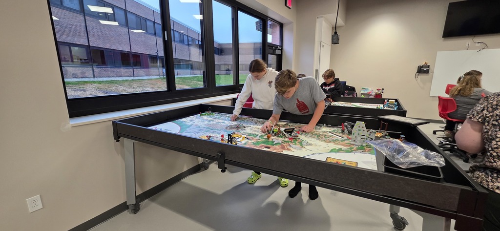 Lila and Lewis working at a First Lego League Table