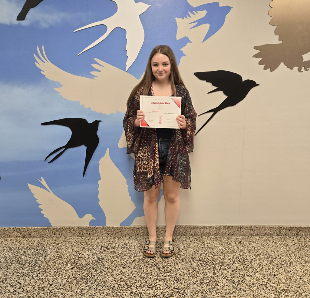 Jayden holding her certificate for Student of the Month