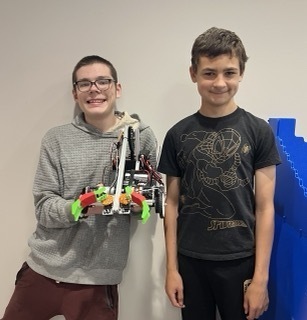 two male students with a robot