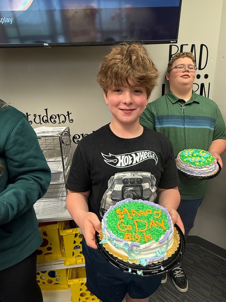 student holding decorated cake